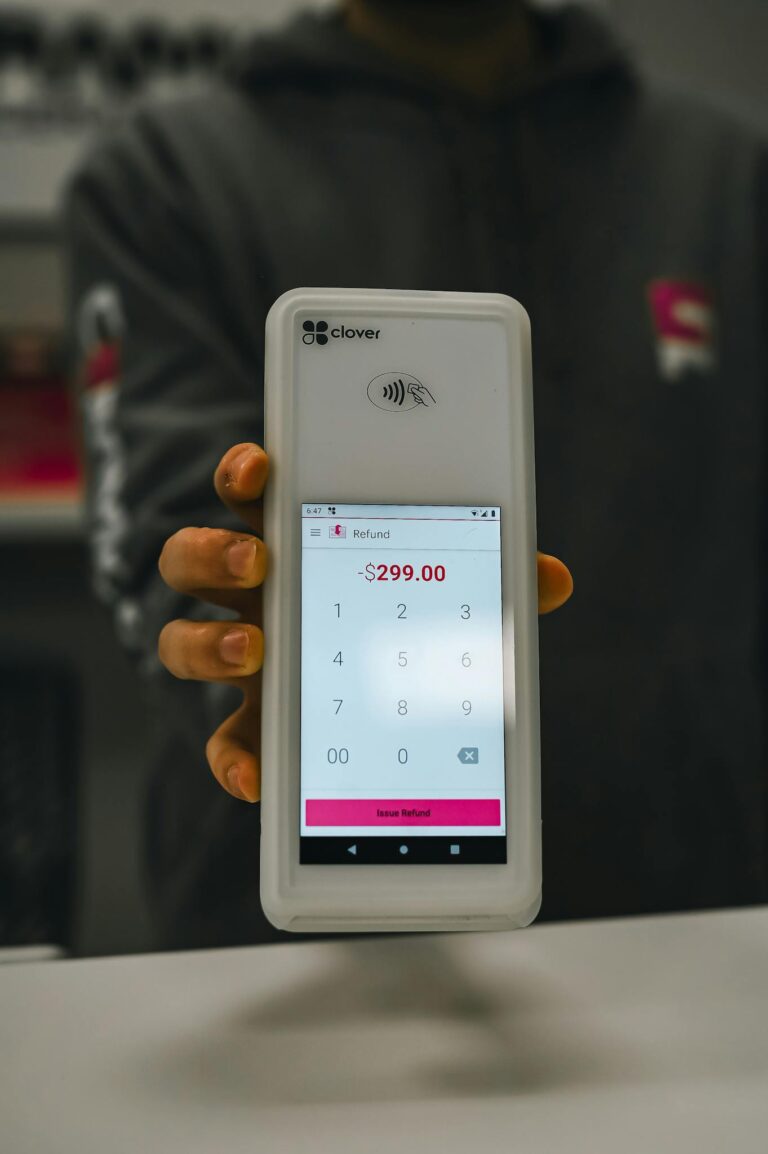 Close-up of a payment terminal showing a $299 refund, illustrating modern contactless payment solutions.